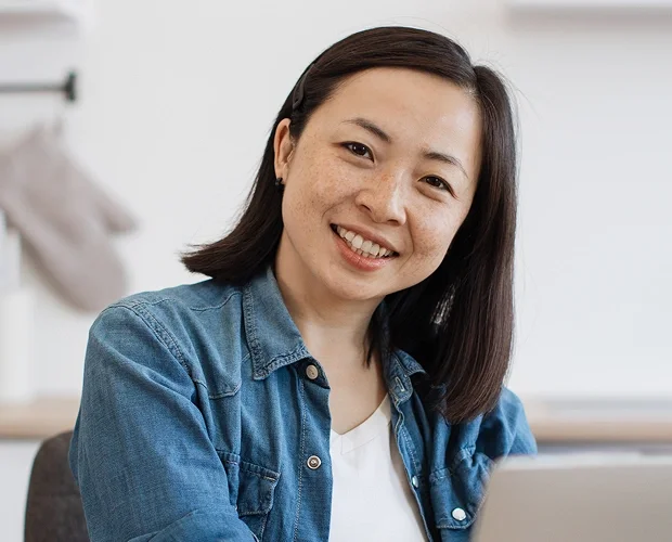 Content moderation representative smiling at desk