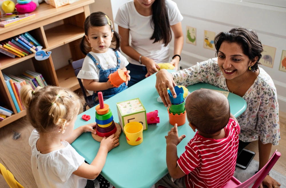 children playing at a table in nursery